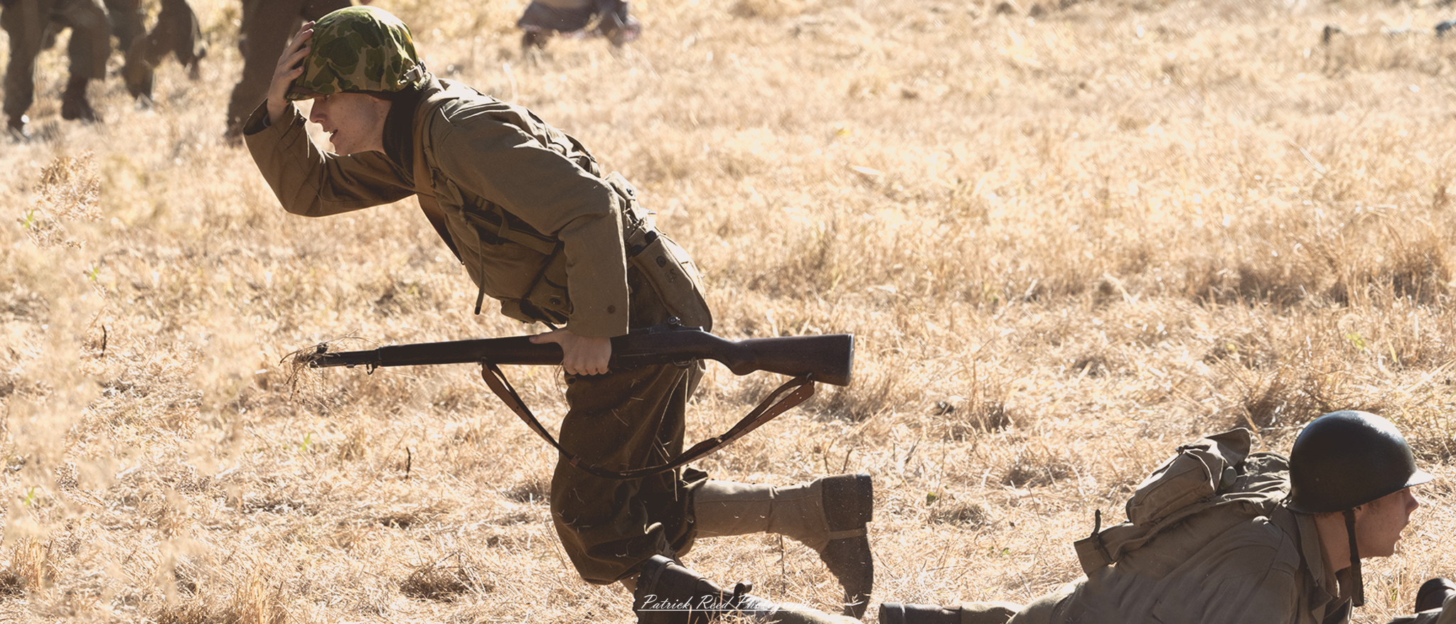 "Action-packed scene of a World War II soldier running across an open field, embodying the urgency and intensity of battle. The soldier, dressed in a standard uniform with gear, sprints with determination, showcasing the effort and adrenaline of wartime movement. The background features a blurred landscape, possibly with smoke or distant explosions, highlighting the chaos of conflict. The focus is on the soldier's expression, conveying bravery and resolve as he navigates the challenging terrain. This dynamic image captures a pivotal moment of courage in the midst of war."